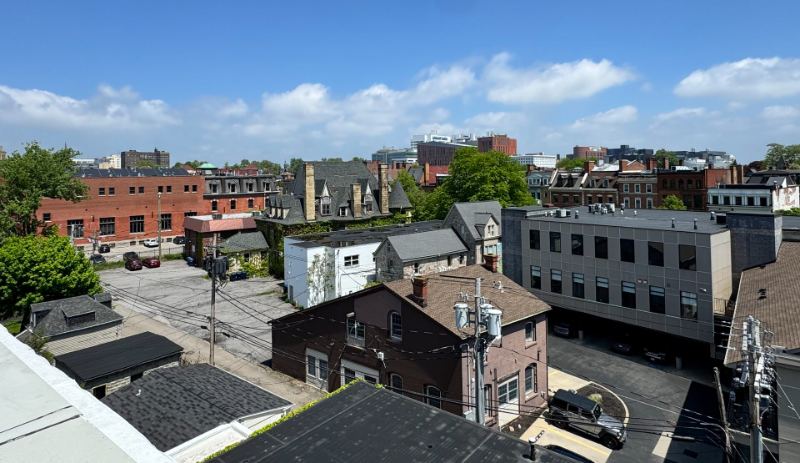 View from the rooftop over neighboring Allentown rooftops toward the city skyline